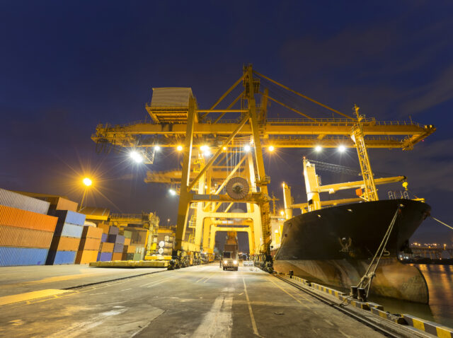 Industrial Container Cargo freight ship with working crane bridg